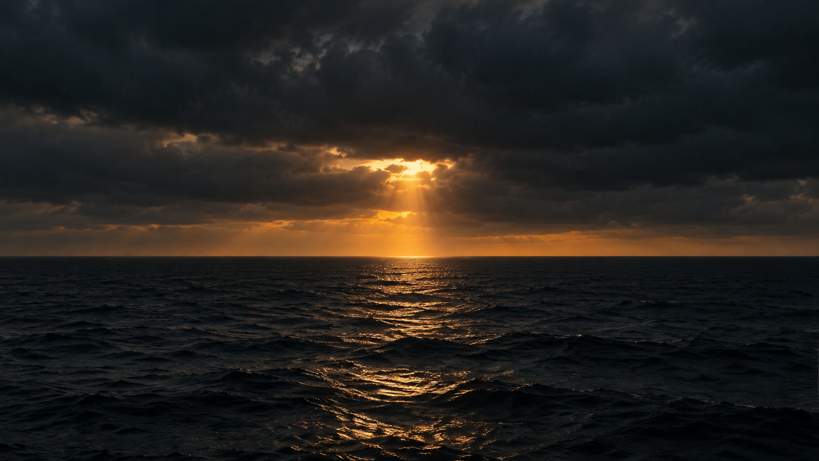 A shaft of sunlight breaking through clouds over a dark sea